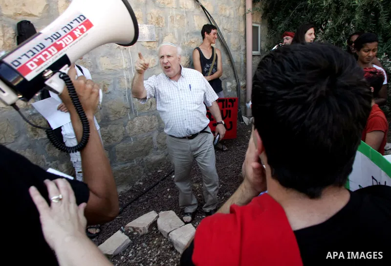 Jewish settler shouts at Israeli, Palestinian and foreign activists as they take part in a weekly demonstration against Israel's occupation of Palestinian land on Jun 24, 2011 in the mostly Arab Jerusalem neighborhood of...