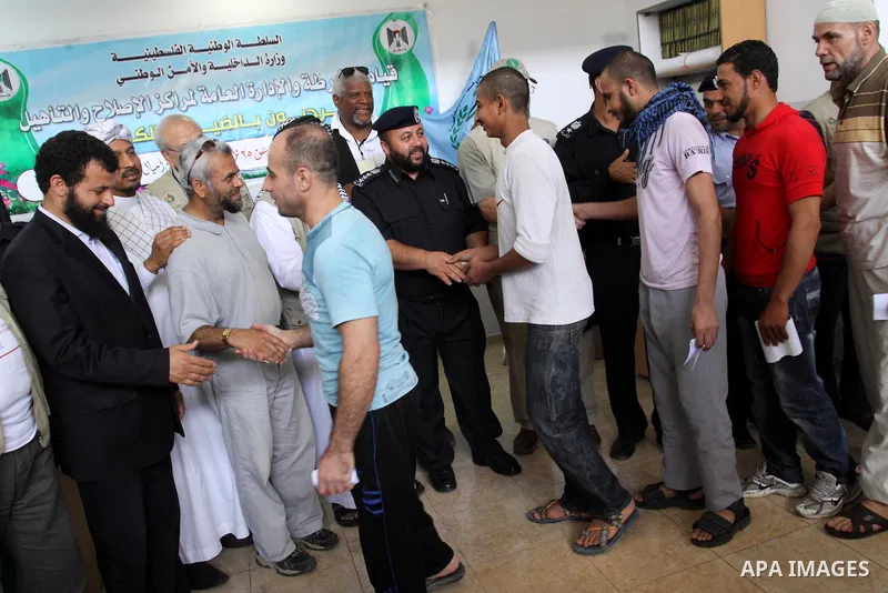 Palestinian prisoners prepare to be freed from a Hamas-run jail in Gaza City on June 25, 2011. Palestinian Hamas policemen released 26 prisoners in the presence of the convoy of "Miles of Smiles 3". Photo by Mohammed Asa...