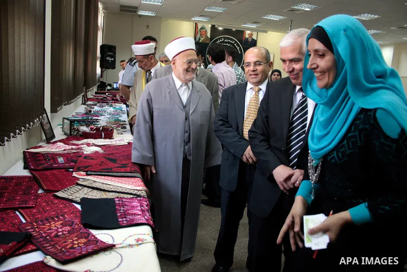 Palestinian governer of Hebron, Kamel Hemad attends the opening of heritage exhibition at Hebron Governate with cooperation of the Palestinian Jerusalem's women association in the Mukaber club, in the West Bank city of H...