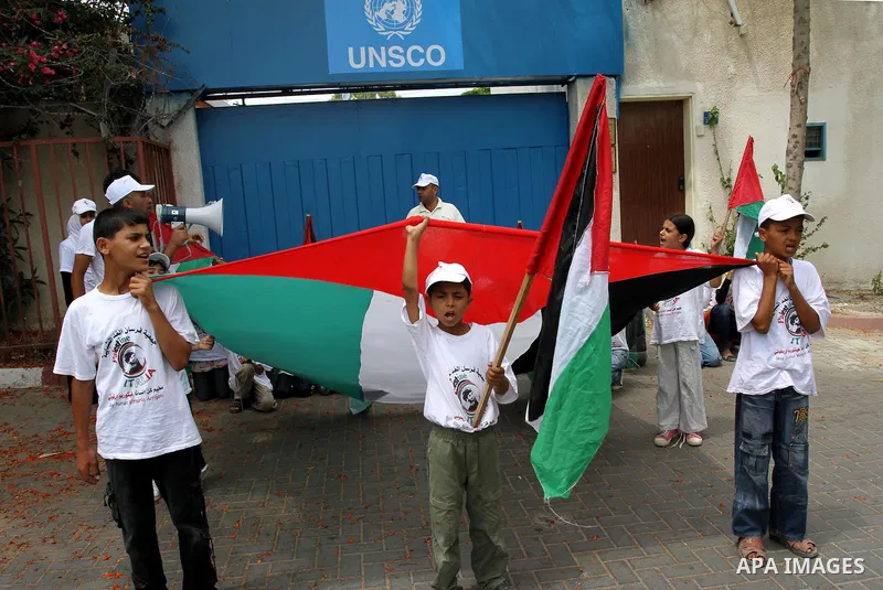 Palestinian boys from NGOs hold national flags during a protest in solidarity with freedom flotilla "2" and to break the seige in front of the UNRWA in Gaza city on June 27, 2011. Photo by Mohammed Asad