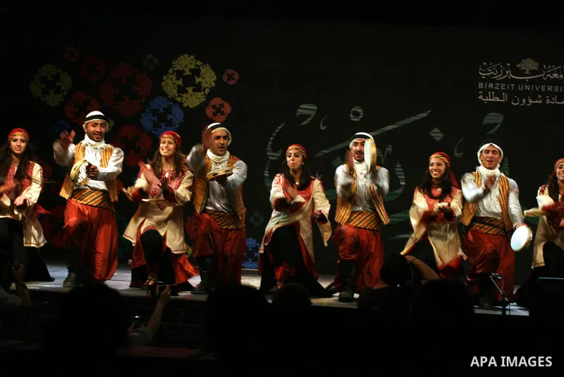 Palestinian dancers from the Wishah Popular Dance Troupe perform the festival "nights of Birzeit" at Birzeit University in the West Bank city of Ramallah on June 28, 2011. Photo by Issam Rimawi