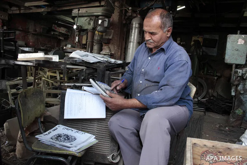 A Palestinian elderly man Elias Abdel-Hay prepares to study in the high school "Twajihi" after he left studing for 47 years in the West Bank city of Hebron on June 29, 2011. Where he completed the ninth-grade for the las...