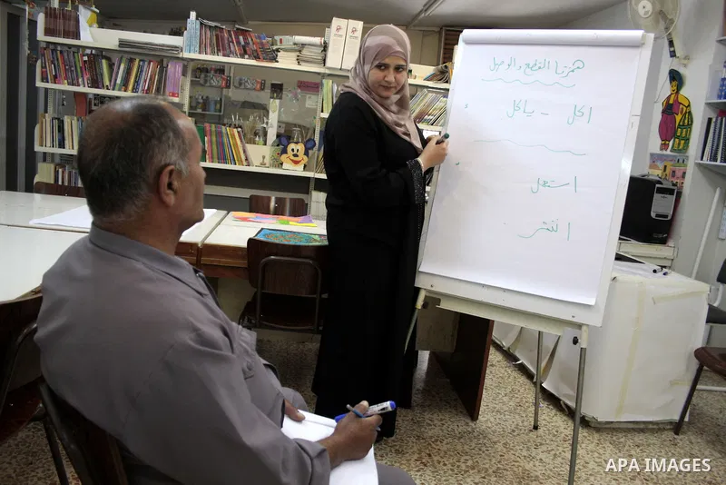 A Palestinian elderly man Elias Abdel-Hay prepares to study in the high school "Twajihi" after he left studing for 47 years in the West Bank city of Hebron on June 29, 2011. Where he completed the ninth-grade for the las...