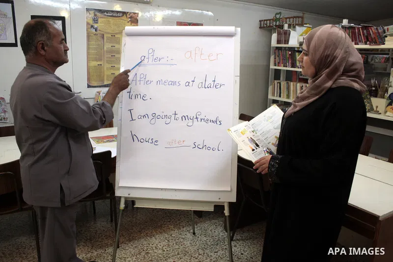 A Palestinian elderly man Elias Abdel-Hay prepares to study in the high school "Twajihi" after he left studing for 47 years in the West Bank city of Hebron on June 29, 2011. Where he completed the ninth-grade for the las...