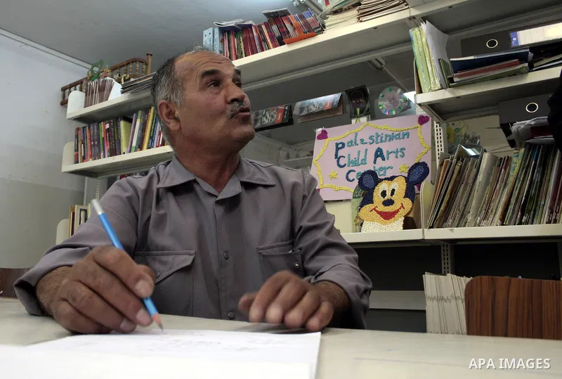 A Palestinian elderly man Elias Abdel-Hay prepares to study in the high school "Twajihi" after he left studing for 47 years old in the West Bank city of Hebron on June 29, 2011. Where he completed the ninth-grade for the...