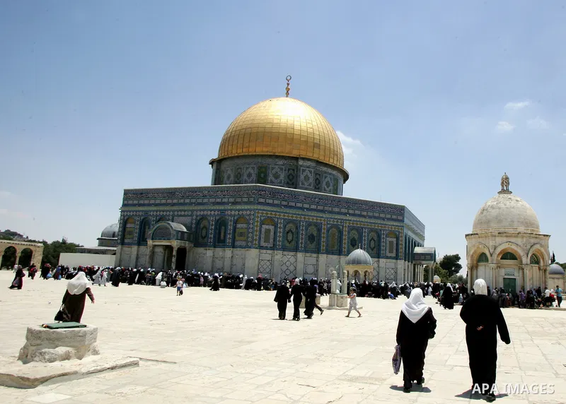 Palestinains walk near the Dome of the Rock in the Al-Aqsa Mosque compound, Islam's third holiest site, in Jerrusalem's old city on June 29, 2011. According to Sheikh Azzam Khatib, the head of the Islamic Waqf in Jerusal...