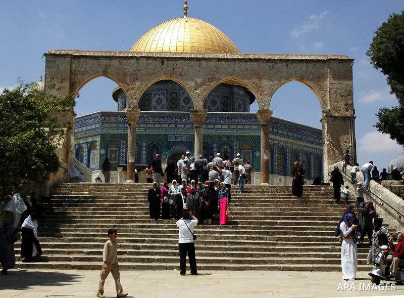 Palestinains pose for pictures near the Dome of the Rock in the Al-Aqsa Mosque compound, Islam's third holiest site, in Jerrusalem's old city on June 29, 2011. According to Sheikh Azzam Khatib, the head of the Islamic Wa...