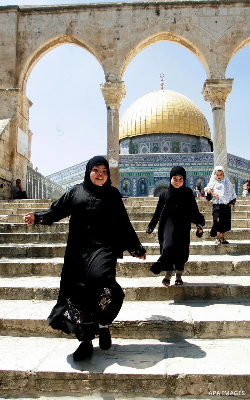 Palestinain girls walk near the Dome of the Rock in the Al-Aqsa Mosque compound, Islam's third holiest site, in Jerrusalem's old city on June 29, 2011. According to Sheikh Azzam Khatib, the head of the Islamic Waqf in Je...