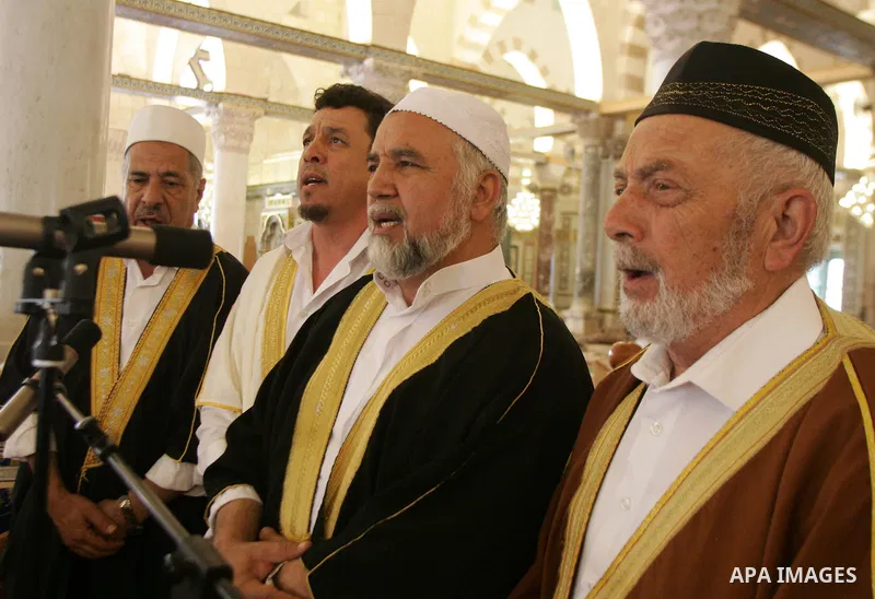 Palestinian men perform nashed (Islamic songs) to mark the anniversary of Al-Isra wa Al-Mearaj inside the Al-Aqsa Mosque in Jerrusalem's old city on June 29, 2011 to prepare it for the fitting of a new carpet. According...