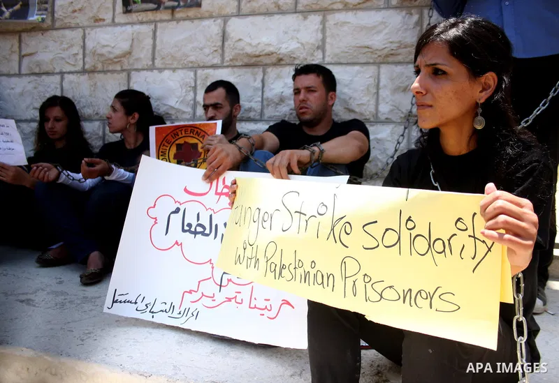 Palestinian youths stage a demonstration in support of Palestinian prisoners and against the International Red Cross on June 29, 2011 in the West Bank city of Ramallah after Israel has moved several of its Hamas prisoner...