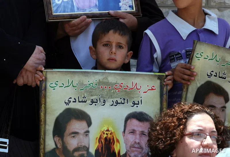 Palestinian youths stage a demonstration in support of Palestinian prisoners and against the International Red Cross on June 29, 2011 in the West Bank city of Ramallah after Israel has moved several of its Hamas prisoner...