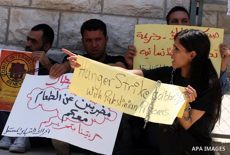 Palestinian youths stage a demonstration in support of Palestinian prisoners and against the International Red Cross on June 29, 2011 in the West Bank city of Ramallah after Israel has moved several of its Hamas prisoner...