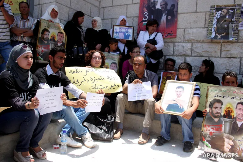 Palestinian youths stage a demonstration in support of Palestinian prisoners and against the International Red Cross on June 29, 2011 in the West Bank city of Ramallah after Israel has moved several of its Hamas prisoner...