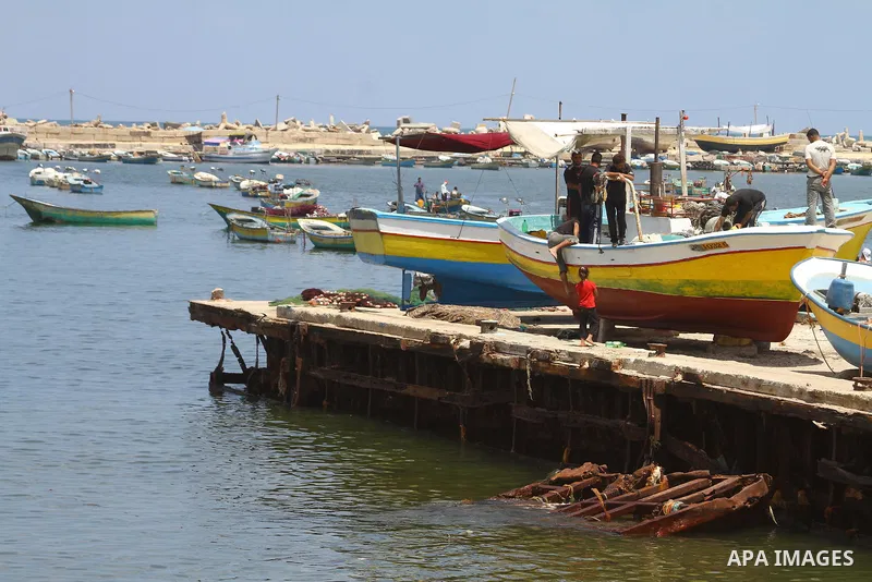 Palestinian boys gather in the port of Gaza during the end of the preparations to support the Freedom flotilla "2" in Gaza city on June 30, 2011. at the site of a monument (unseen) built to commemorate the first annivers...
