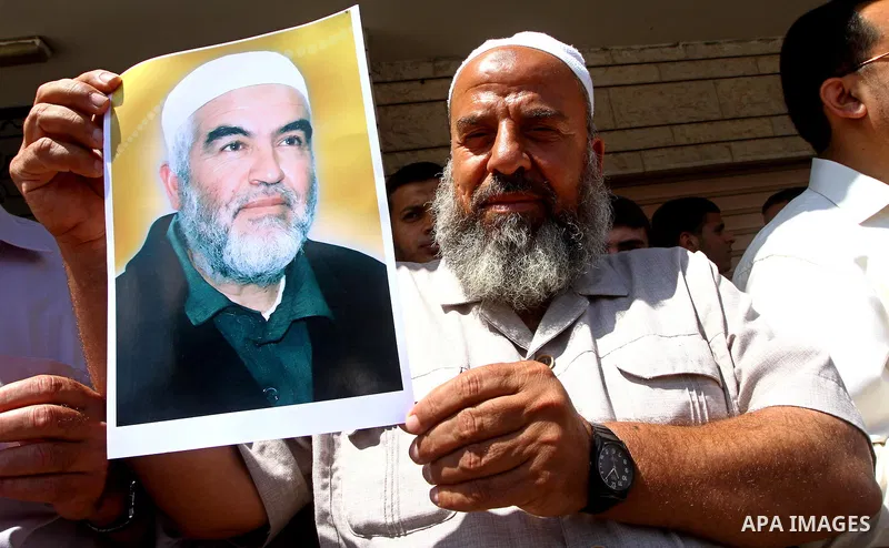 Supporters of Sheikh Raed Salah (portrait), head of the radical wing of the Islamic Movement in Israel, demonstrate in Gaza City on June 30, 2011 after the controversial Arab-Israeli Islamist leader was arrested in Londo...