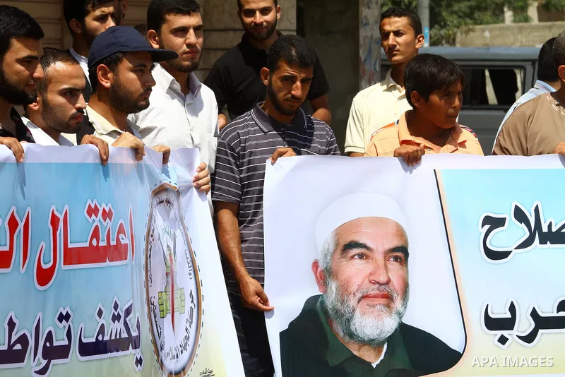 Supporters of Sheikh Raed Salah (portrait), head of the radical wing of the Islamic Movement in Israel, demonstrate in Gaza City on June 30, 2011 after the controversial Arab-Israeli Islamist leader was arrested in Londo...