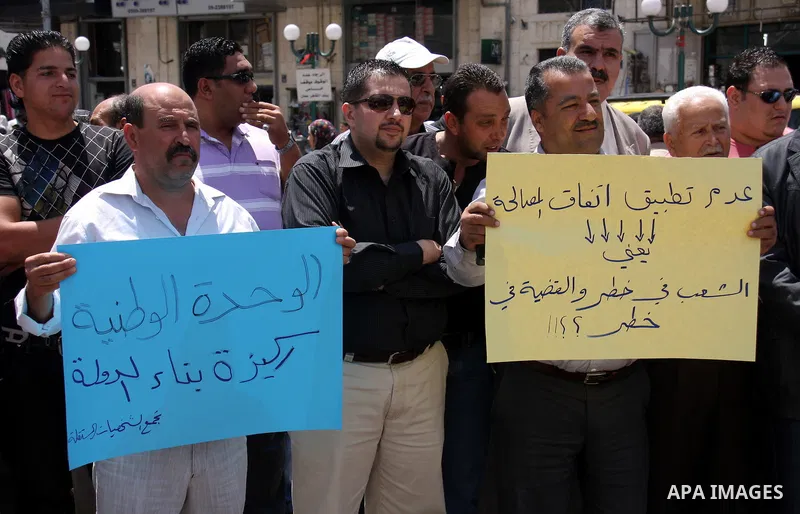 Palestinian demonstrators take part in a protest calling for Palestinian political unity between Gaza's Hamas rulers and the Fatah-dominated Palestinian Authority which rules from Ramallah, Thursday, June 30, 2011. Photo...