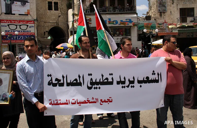 Palestinian demonstrators take part in a protest calling for Palestinian political unity between Gaza's Hamas rulers and the Fatah-dominated Palestinian Authority which rules from Ramallah, Thursday, June 30, 2011. Photo...
