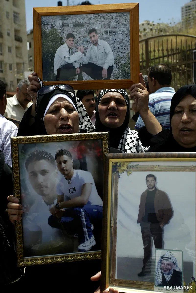 Palestinians women hold pictures of their relatives, during a protest calling for the release of Palestinian prisoners from Israeli jails, in the West Bank city of Nablus Thursday, June 30, 2011. Israel currently holds a...