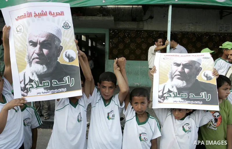 Palestinian children Supporters of Sheikh Raed Salah (portrait), head of the radical wing of the Islamic Movement in Israel, demonstrate in Rafah in the southern Gaza Strip on June 30, 2011 after the controversial Arab-I...