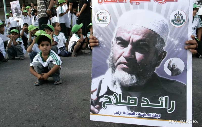 Palestinian children Supporters of Sheikh Raed Salah (portrait), head of the radical wing of the Islamic Movement in Israel, demonstrate in Rafah in the southern Gaza Strip on June 30, 2011 after the controversial Arab-I...