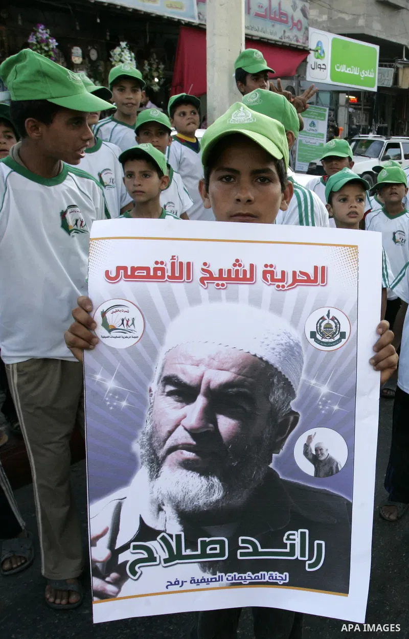 Palestinian children Supporters of Sheikh Raed Salah (portrait), head of the radical wing of the Islamic Movement in Israel, demonstrate in Rafah in the southern Gaza Strip on June 30, 2011 after the controversial Arab-I...