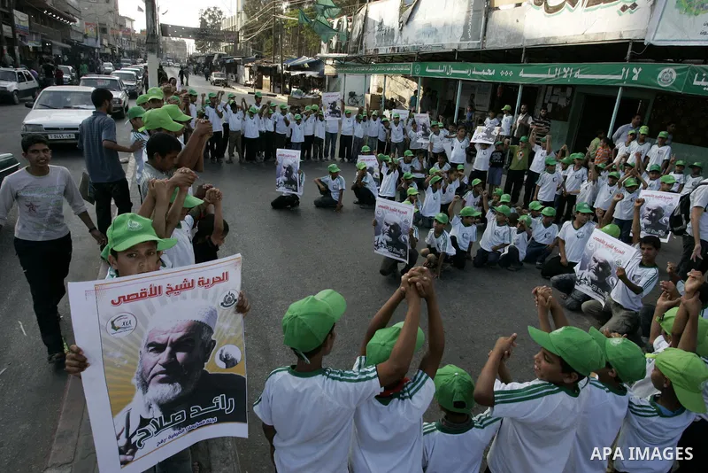 Palestinian children Supporters of Sheikh Raed Salah (portrait), head of the radical wing of the Islamic Movement in Israel, demonstrate in Rafah in the southern Gaza Strip on June 30, 2011 after the controversial Arab-I...