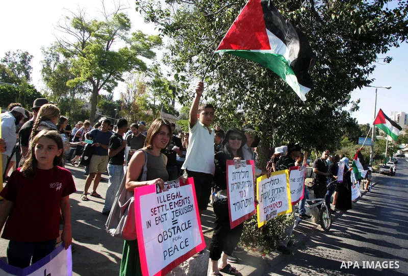 Israeli, Palestinian and foreign activists take part in a weekly demonstration against Israel's occupation of Palestinian land on July 1, 2011 in the mostly Arab Jerusalem neighborhood of Sheikh Jarrah. Photo by Mahfouz...