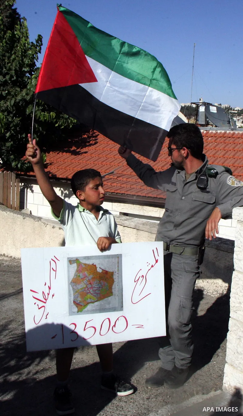 Israeli, Palestinian and foreign activists take part in a weekly demonstration against Israel's occupation of Palestinian land on July 1, 2011 in the mostly Arab Jerusalem neighborhood of Sheikh Jarrah. Photo by Mahfouz...