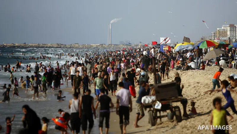 Palestinians enjoy swimming in the sea on Gaza's beach on July 1, 2011 in Gaza City. Photo by Ali Jadallah