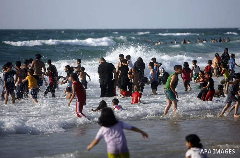 Palestinians enjoy swimming in the sea on Gaza's beach on July 1, 2011 in Gaza City. Photo by Ali Jadallah