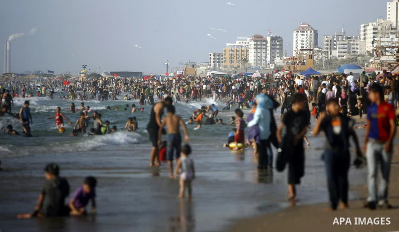 Palestinians enjoy swimming in the sea on Gaza's beach on July 1, 2011 in Gaza City. Photo by Ali Jadallah