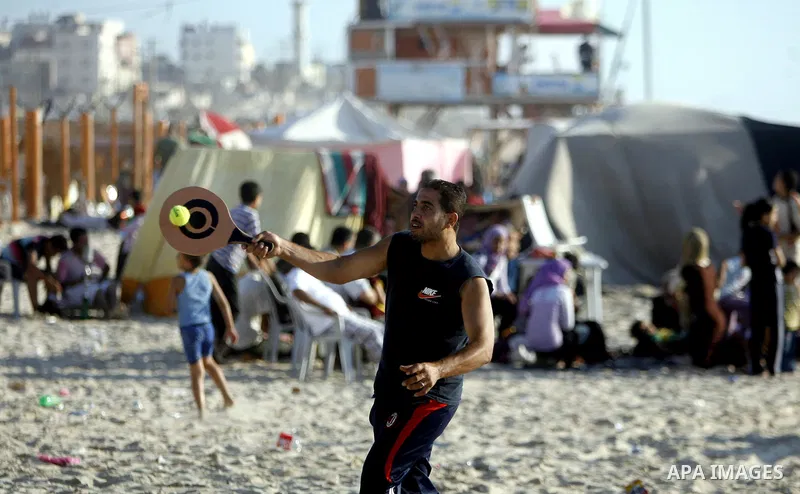 Palestinians enjoy swimming in the sea on Gaza's beach on July 1, 2011 in Gaza City. Photo by Ali Jadallah