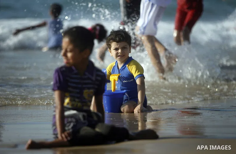Palestinians enjoy swimming in the sea on Gaza's beach on July 1, 2011 in Gaza City. Photo by Ali Jadallah