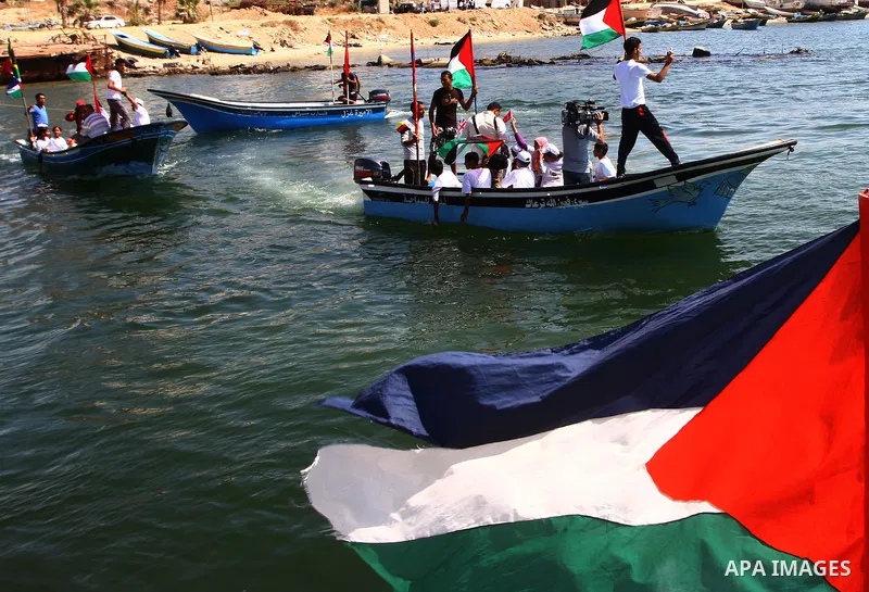 Palestinians ride on boats at the port of Gaza City during a rally in support of the Gaza-bound international Freedom Flotilla hoping to breach Israel's sea blockade on Gaza as it was banned by Greece from setting sail o...