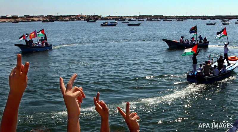Palestinians ride on boats at the port of Gaza City during a rally in support of the Gaza-bound international Freedom Flotilla hoping to breach Israel's sea blockade on Gaza as it was banned by Greece from setting sail o...