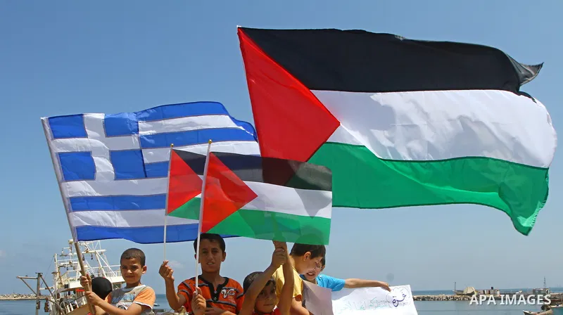 Palestinian children wave Palestinian flags along with the national flags of activists taking part in the Gaza-bound international Freedom Flotilla hoping to breach Israel's sea blockade on Gaza during a rally in Gaza Ci...