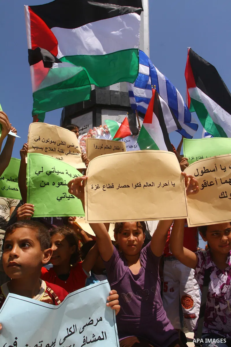 Palestinian children wave Palestinian flags along with the national flags of activists taking part in the Gaza-bound international Freedom Flotilla hoping to breach Israel's sea blockade on Gaza during a rally in Gaza Ci...