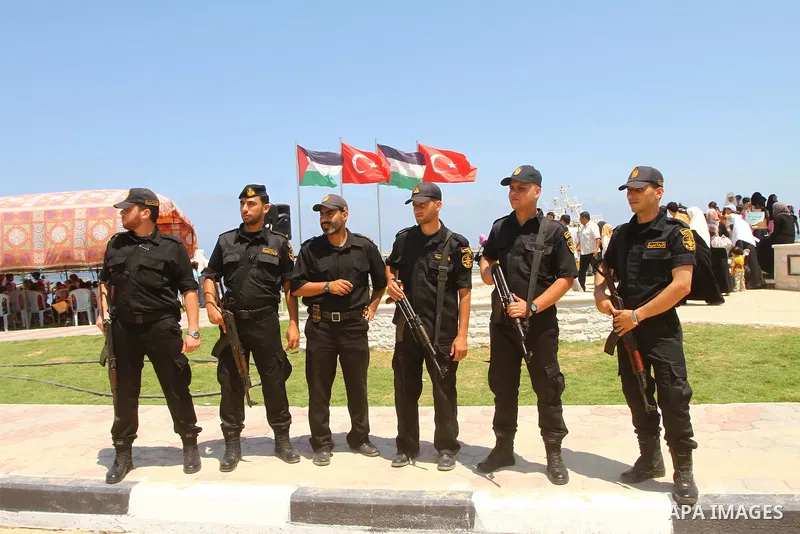 Palestinian Hamas police officers stand guard next to a memorial site in memory of nine Turkish activists who were killed in a deadly raid by the Israeli army on a Turkish aid ship bound for the Gaza Strip last year, in...