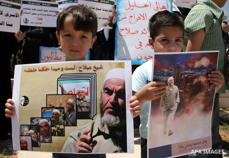 Supporters of Sheikh Raed Salah, head of the radical wing of the Islamic Movement in Israel, demonstrate outside the Red Cross office in the West Bank city of Hebron, on July 03 ,2011 after the controversial Arab-Israeli...