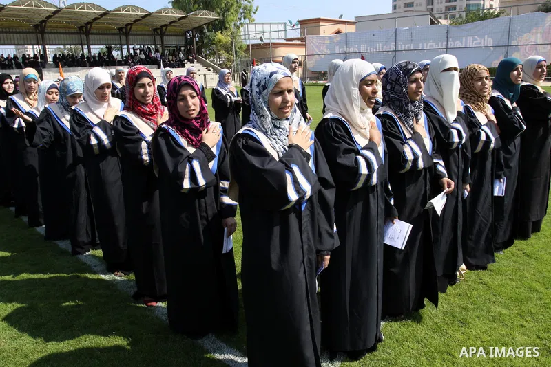 Palestinian students are seen during their training in preparation for graduation ceremony that starting tomorrow in the Islamic University in Gaza city on July 3, 2011. Photo by Mohammed Asad