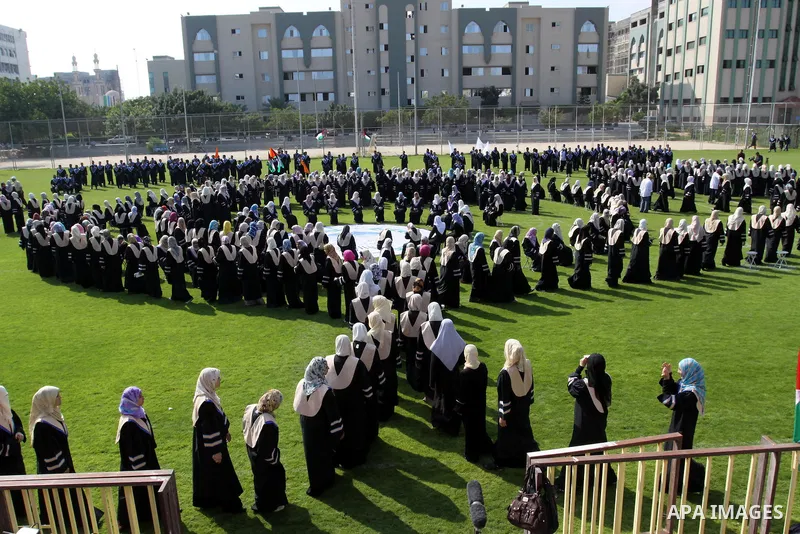 Palestinian students are seen during their training in preparation for graduation ceremony that starting tomorrow in the Islamic University in Gaza city on July 3, 2011. Photo by Mohammed Asad