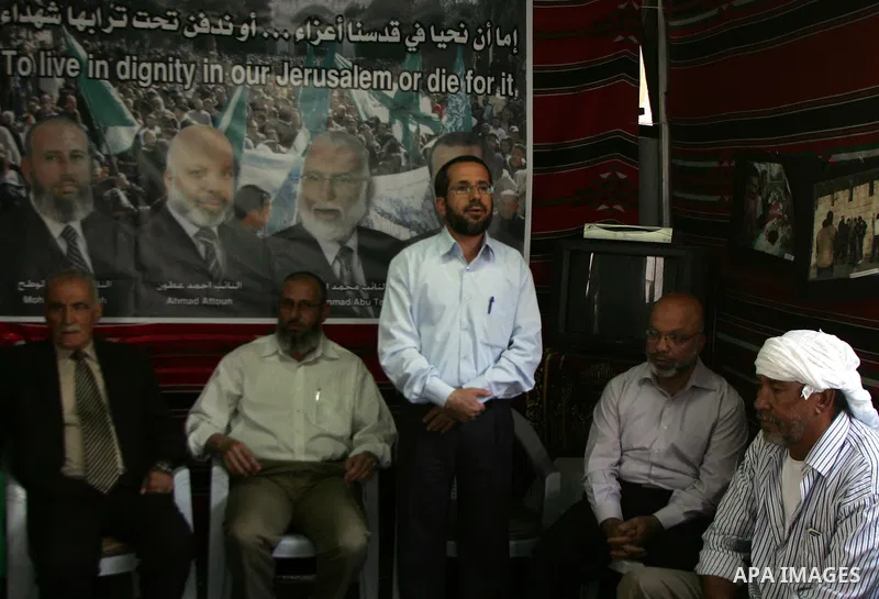 Palestinian Hamas legislators Ahmed Atun, Mohammed Totah and Khaled Abu Arafa receive Palestinian supporters at the Red Cross compound in east Jerusalem on July 3, 2011. The Hamas MPs live inside the compound for the pas...