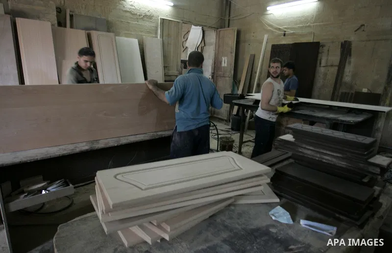 Palestinian carpenters work at their furniture carpentry workshop in Rafah, southern Gaza Strip on July 3,2011. Photo by Abed Rahim Khatib