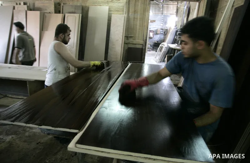 Palestinian carpenters work at their furniture carpentry workshop in Rafah, southern Gaza Strip on July 3,2011. Photo by Abed Rahim Khatib