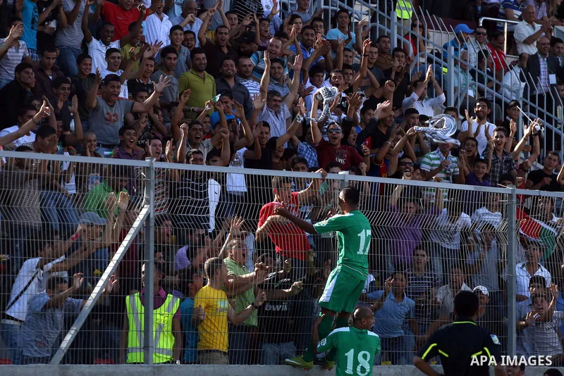 Palestinian players celebrate after a goal during a soccer match between the Palestinian and Afghanistan national teams in the West bank city of Ramallah, Sunday July 3, 2011. The Palestinian national soccer team drew 1-...
