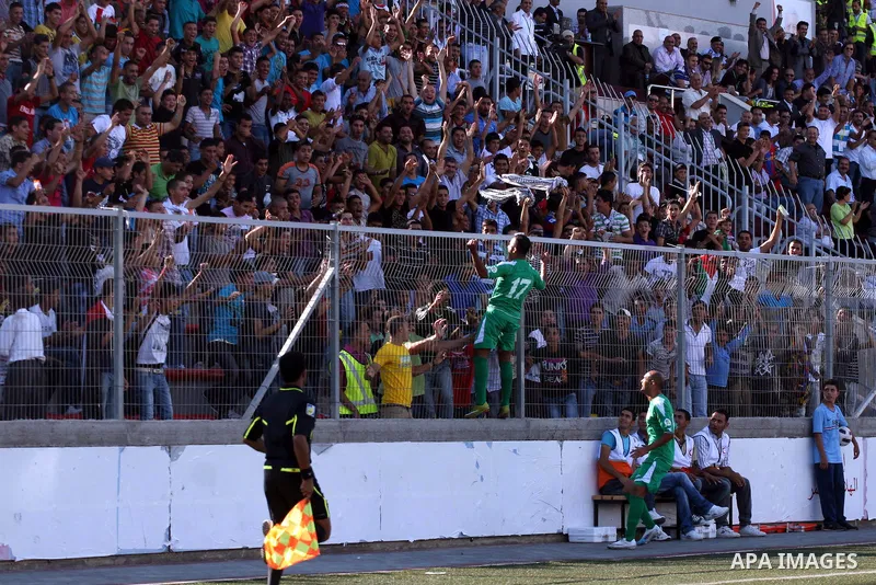 Palestinian players celebrate after a goal during a soccer match between the Palestinian and Afghanistan national teams in the West bank city of Ramallah, Sunday July 3, 2011. The Palestinian national soccer team drew 1-...