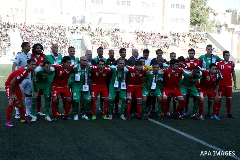 Palestinian players and Afghanistan players pose for pictures during a soccer match between the Palestinian and Afghanistan national teams in the West bank city of Ramallah, Sunday July 3, 2011. The Palestinian national...