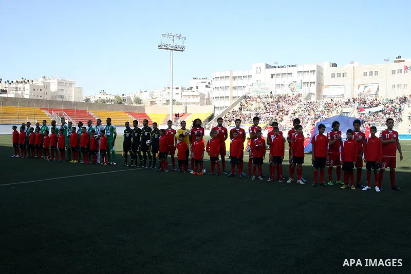 Palestinian players and Afghanistan players pose for pictures during a soccer match between the Palestinian and Afghanistan national teams in the West bank city of Ramallah, Sunday July 3, 2011. The Palestinian national...