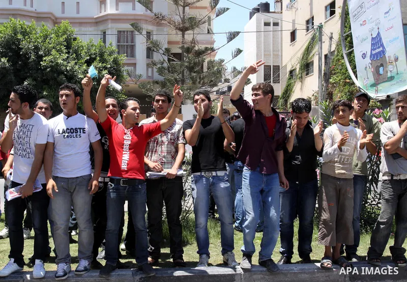 Palestinian students take a part in a protest in front of the headquarters of the Ministry of Education after the end of exams and they object to the difficulty of the exams in Gaza city on July 4, 2011. Photo by Mohamme...
